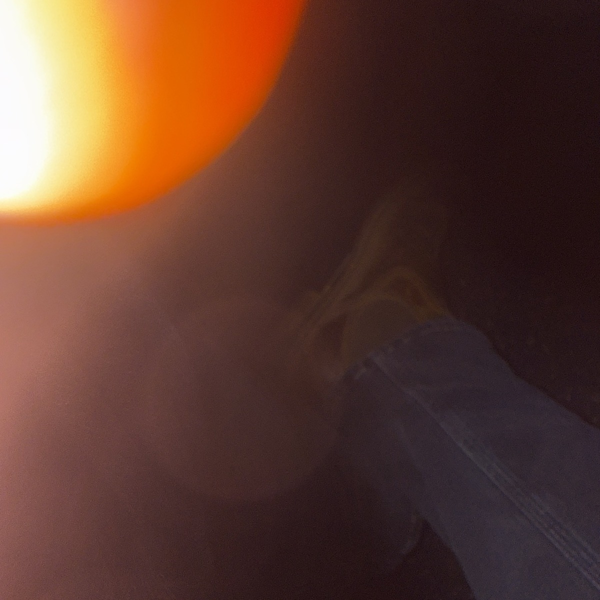 blurred orange light and a figure in motion